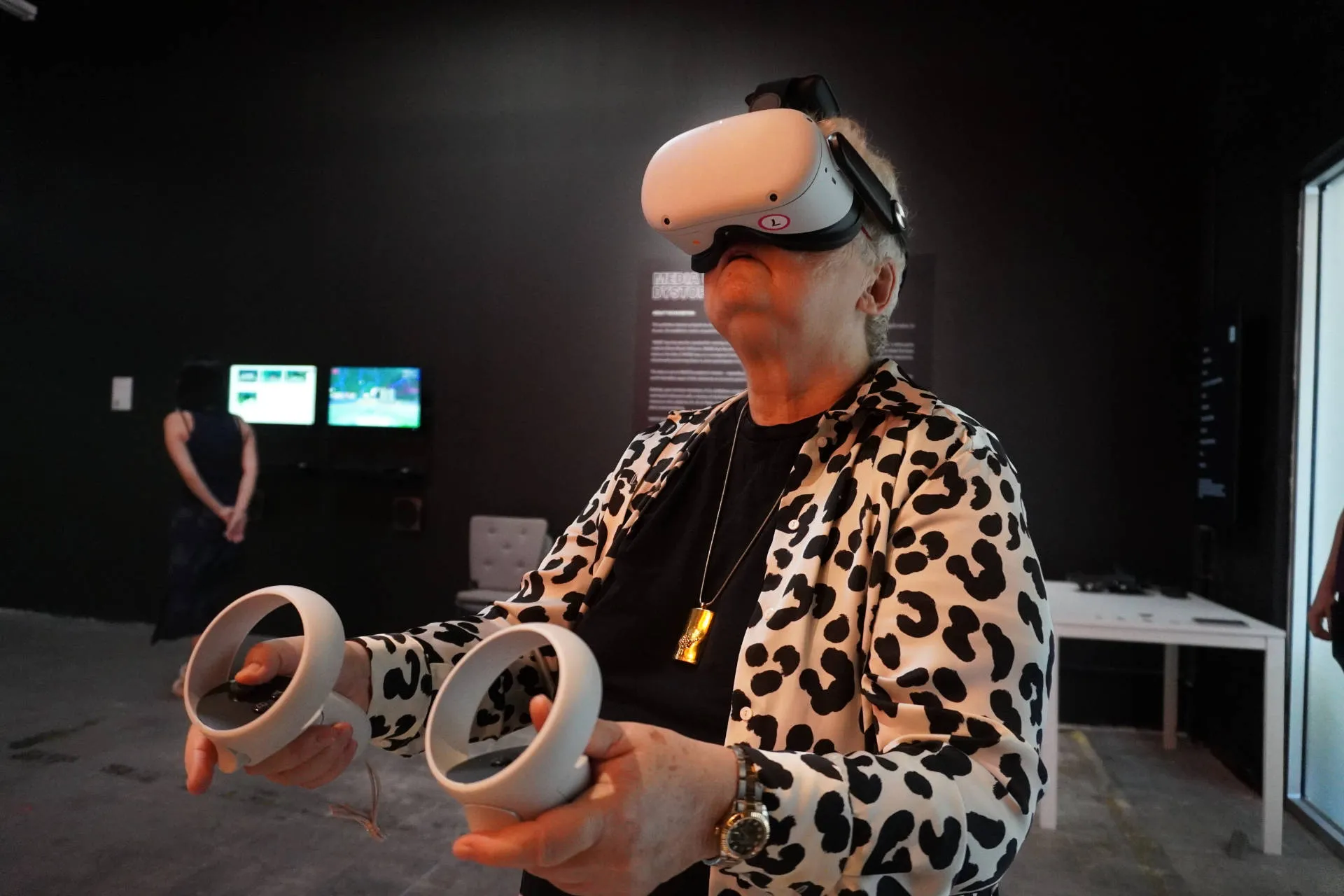 A person using a Oculus VR headset at the MUD exhibition, inmersed in virtual reality